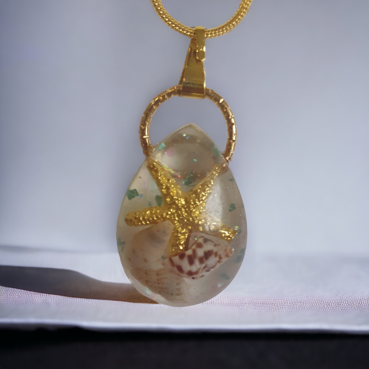 Pendant teardrop gold seastar with seashells